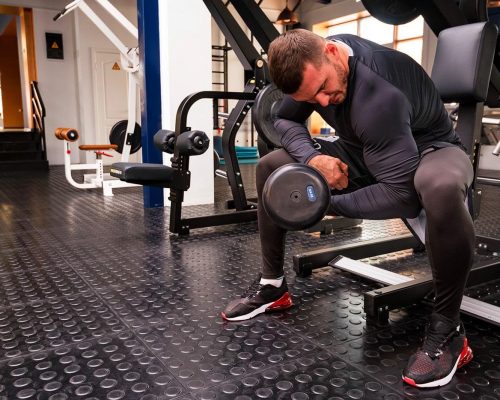 male-athlete-doing-biceps-exercise-with-dumbbells-X32HPD6-min.jpg